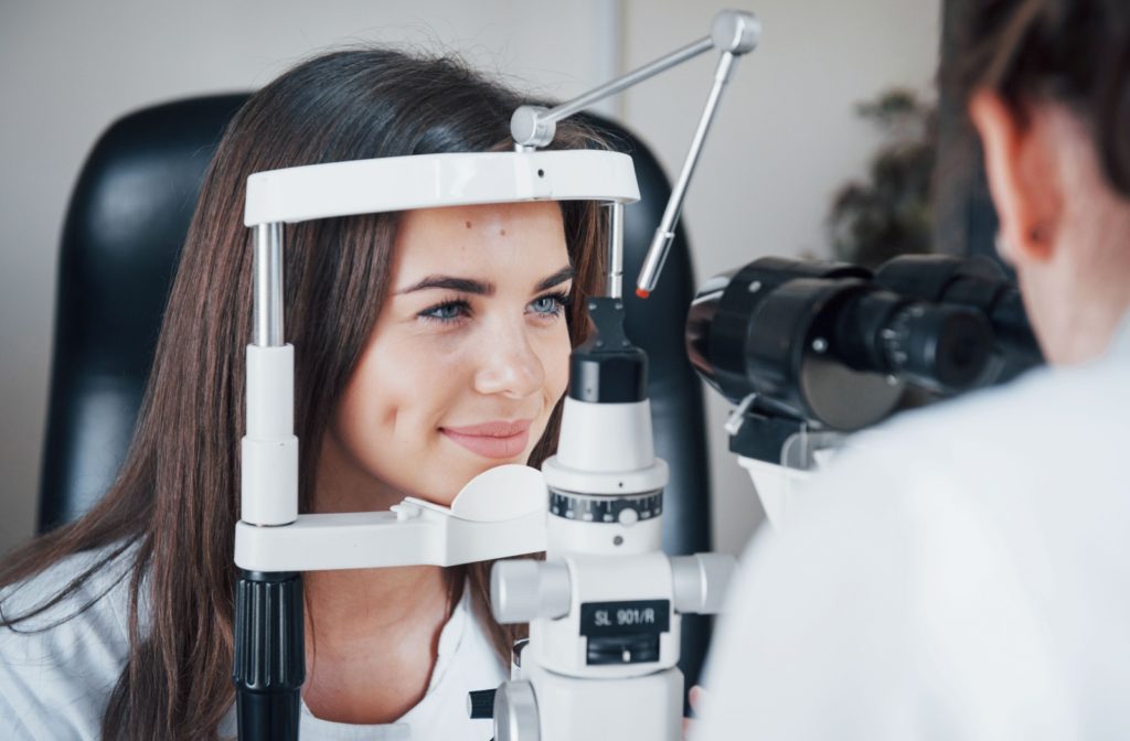 A young woman with piercing blue eyes undergoing an eye examination.