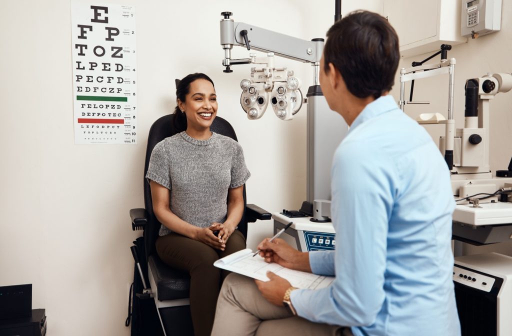 A patient discusses their vision with their optometrist during a laser eye surgery consultation.